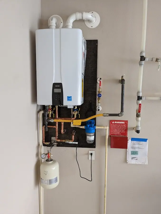 Professional plumber installing copper piping in a Nebraska City home